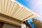 Awning over balcony window against blue sky