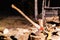 Ax with wooden handle is stuck in wooden stump on background of chopped wood. Old carpenter\'s ax for cutting firewood sticks out