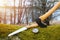 Axe, saw and compass on moss in forest. Travel, adventure, camping gear, outdoors items