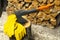 axe stuck in a wooden deck and protective yellow leather gloves