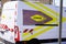 Aximum logo sign and brand text on panel van of company Road equipment subsidiary of