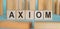 AXIOM word made with building blocks on a blue background