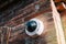 Axis 360 degrees surveillance camera on brick wall
