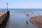 AXMOUTH, DEVON,ENGLAND - JULY 12TH 2020: Men and women in canoes make there way against the current in the mouth of the river Axe