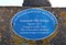 AXMOUTH, DEVON,ENGLAND - JULY 12TH 2020: The plaque on the old bridge over the river Axe at Axmouth