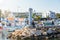 AYIA NAPA, CYPRUS - August 10, 2019: View of Ayia Napa harbor with white lighthouse tower on a breakwater