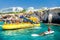 AYIA NAPA, CYPRUS - August 12, 2019: Yellow pleaseure boat full of tourists along the coast of Ayia Napa. Famagusta district.