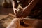 An Ayurvedic abhyanga massage in progress, showing hands rhythmically prepare herbal oils to a warm skin. Capture the rejuvenating