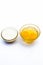 Ayurvedic calcium supplement ingredients on white i.e. Raw eggs with milk.