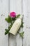 Ayurvedic drink pink milk or matcha. A glass bottle of milk lies on a table with a pink rose. Top view and selective