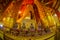 AYUTTHAYA, THAILAND, FEBRUARY, 08, 2018: Indoor view of clay monks close to a giant golden budha statue covered with a