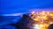 Azenhas do Mar village at dusk with stormy sea and dark clouds,