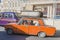 Azerbaijan, Baku-April 10, 2018; An old rusty car of the Fiat Lada model carries old scrap metal on the roof trunk . The driver of