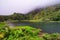 Azores scenic landscape, Flores island. Iconic lagoon with over 20 separate waterfalls on a single rockface, flowing into lake Ala