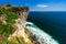 Azure beach with rocky mountains and clear water of Indian ocean at sunny day / A view of a cliff in Bali Indonesia