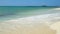Azure coast of the caribbean sea. White sand and light waves. 4K