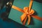 Azure gift box with an orange bow close up