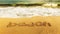 Azure ocean with inscription BEACH on the yellow sand.