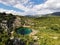 Azure pond in a green mountainous area