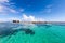 Azure turquoise blue lagoon, small uninhabited reef island motu full of dangerous rocks and mangroves trees. Pohnpei, Micronesia.