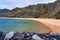 Azure water in a quiet tourist bay with a mountain chain. Illustrating leisure