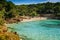 Azure waters and picturesque coastline in the Cala Gat beach, Mallorca