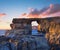 Azure window, natural stone arch by Dwejra cliffs on a sunset
