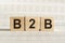 B2B abbreviation - business marketing, on wooden cubes on a light background