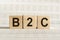 B2C abbreviation - Business to Consumer, on wooden cubes on a light background