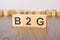 b2g text on wooden blocks. wooden background. foreground