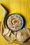 Baba ganoush or mutabal, Middle Eastern eggplant dip sauce garnished with pomegranate seeds with a rustic napkin and pita bread