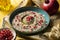 Baba ganoush or mutabal, Middle Eastern eggplant dip sauce garnished with pomegranate seeds, with various ingredients