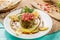 Baba Ghanouj with lemon slice served in a dish isolated on cutting board side view