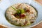 Baba ghanoush, also spelled baba ganoush or baba ghanouj, is an appetizer of mashed cooked eggplant