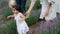 Babby daughter running with parents in lavender field.