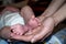 Babby foot in mother hand, childhood birth baby