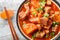 Babi Tomat Pork belly stewed with tomatoes, onions, sweet soy sauce and spices close-up in a bowl. Horizontal top view