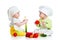 Babies boy and girl with vegetables