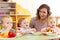 Babies and carer together eat fruits and vegetables as a snack in the kindergarten, nursery or daycare