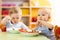 Babies children eating healthy food in nursery or kindergarten