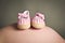 Babies first shoes on a pregnant womans bump