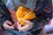 Babies hand holding a piece of juicy fresh orange. healthy eating. playing with fruits. learning from nature. Raw biological food