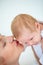 Babies have that special scent...Closeup shot of a mother tenderly kissing her newborn babys head.