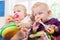 Babies with pacifier in toddler group playing with toys