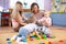 Babies play and their mothers communicate in playroom