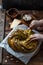 Babka Brioche Wreath with Pesto and Parmesan with hands