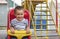 Baby 2 years riding on a swing. Happy child on the playground