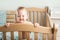 The baby 8 months old is crying on bed. Sleep of a baby in a crib, falling asleep on its own, waking up, colic, teething