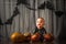 Baby 8 months with pumpkins for Halloween. Infant at home with pumpkin harvest and wearing skeleton costume