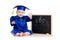 Baby in academician clothes sitting at chalkboard